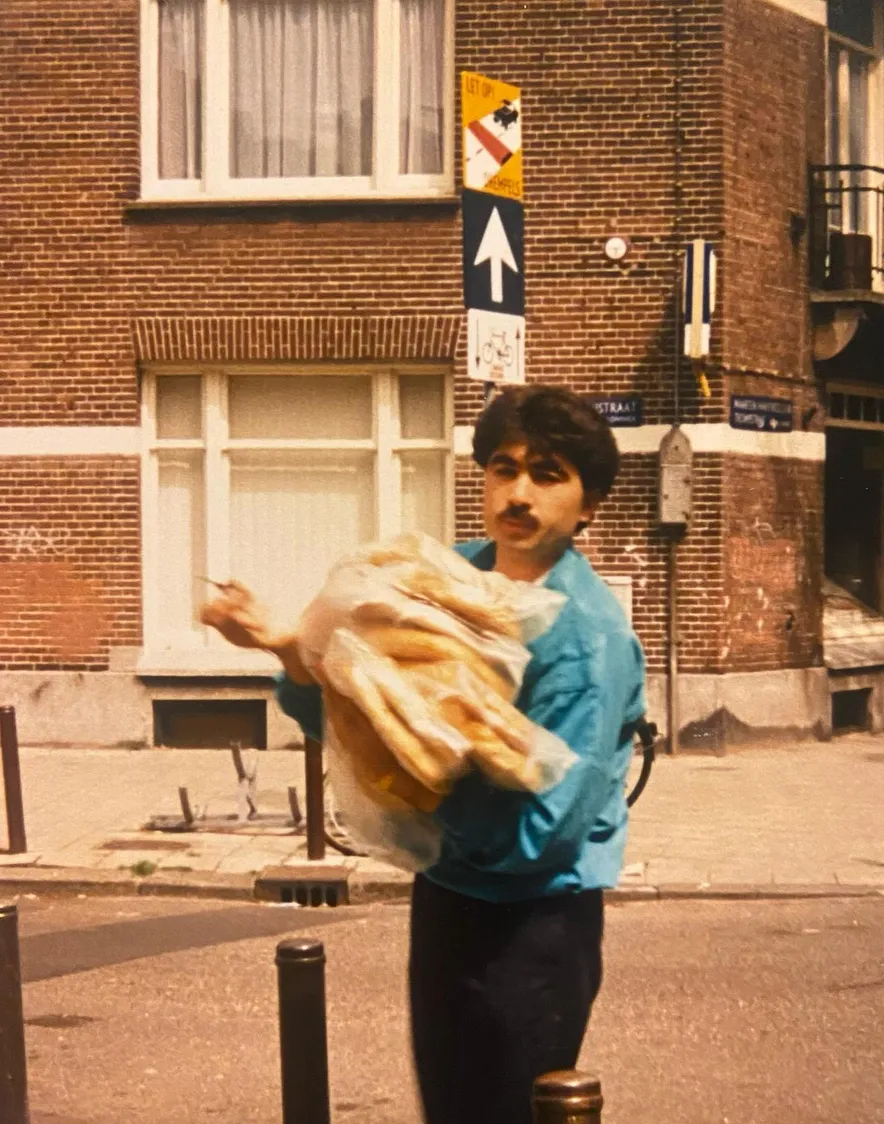 Burcu's father carrying loaves of pide on an Amsterdam street